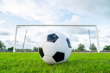 Fototapeta premium Footballs on the field and goal nets in a large stadium