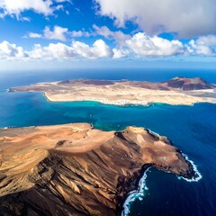 Aerial view of a scenic volcanic island featuring dark rocky terrains, vibrant blue waters, and a distant island under a cloudy sky