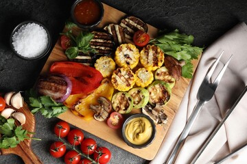 Vegetarian barbeque. Tasty grilled vegetables served on grey table, flat lay