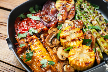 Delicious grilled vegetables, mushrooms and spices in pan on table, closeup