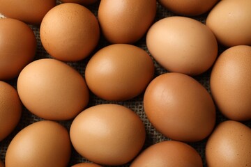 Many raw chicken eggs on table, above view