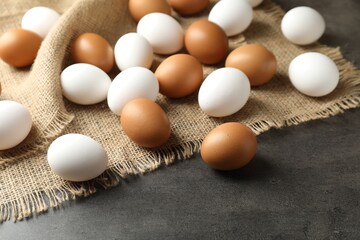 Many raw chicken eggs on grey table