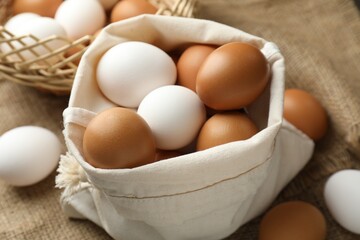 Different raw chicken eggs on table, closeup