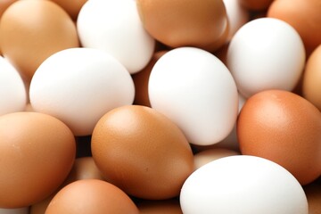 Many raw chicken eggs as background, closeup