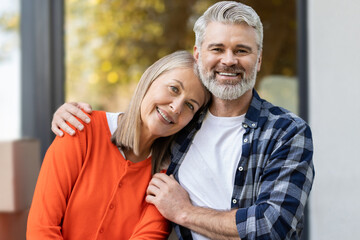 Fototapeta premium Older man and woman relaxing together at their new house entrance