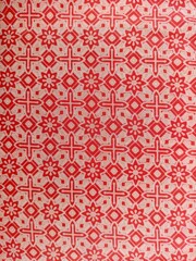 Seamless Batik or textile repeat pattern in pink and red color
