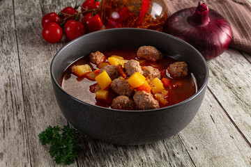 Tomato soup with meatballs and vegetables