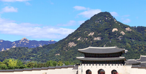 Horizontal banner with Gwanghwamun Gate of Gyeongbokgung palace complex and Inwangsan Mountain,  Seoul, Republic of Korea. Topic of summer vacation, travel, trip abroad on vacation, cruises and tours