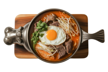 Beef cooked in a hot plate with gravy, eggs and corn which is a westernized. Plate of beef dish in Vietnamese transparent