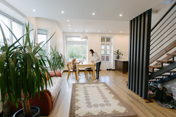 Woman and a kid drawing indoors
