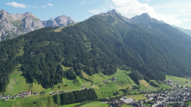 Aerial view of Elferspitze, Zw&ouml;lfernieder and the village Neustift amid the alpine scenery of the Stubai Alps in the Tyrol region of Austria in summer