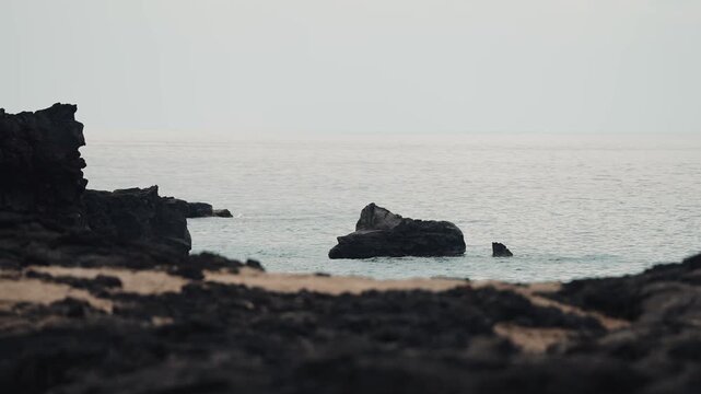 Volcanic rock coastline with blue ocean waves and sea views 4k60p