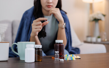 Woman holding pill considering medication for sickness