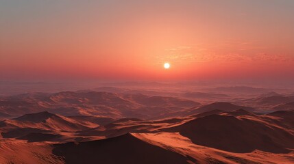 Naklejka premium Sunset over vast desert landscape with rolling sand dunes illuminated by warm colors in the sky
