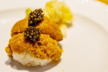 Gourmet sushi with sea urchin and caviar served on elegant plate