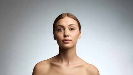 Woman with surgical markings looking directly showing confidence and calm before cosmetic...