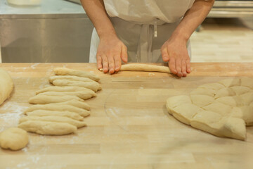 Baker preparing dough wooden countertop various shapes and textures environment