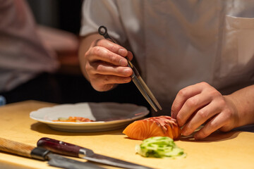 Skilled chef preparing fresh sushi with precision and attention to detail