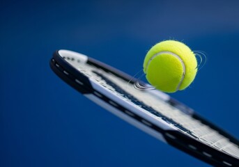 Dynamic yellow tennis ball striking racket, precise moment of athletic power