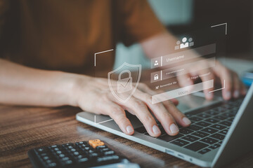 User entering login credentials on a laptop with a virtual security interface and shield icon, cybersecurity and data protection. Concept network security, and safe access to digital services.
