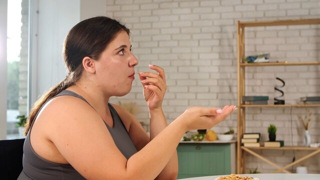 A woman enjoying breakfast in a modern kitchen setting, capturing a moment of mindful eating and relaxation.