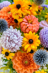 Summer bouquet. Beautiful orange, yellow and blue fresh flower arrangement. Birthday or weddding bouquet made of summer flowers close up.