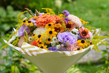 Summer bouquet. Beautiful orange, yellow and lavender fresh flower arrangement. Birthday or weddding bouquet made of summer flowers.