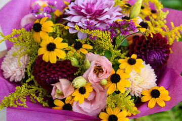 Summer bouquet. Beautiful peach, yellow, purple, magenta, fuchsia and burgundy fresh flower arrangement. Birthday or weddding bouquet made of summer flowers.