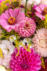 Summer bouquet. Beautiful pink dahlias, lisianthus and zinnias arrangement. Birthday or wedding bouquet made of summer flowers close up.