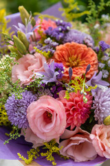 Summer bouquet. Beautiful purple, blush and orange fresh flower arrangement. Birthday or weddding bouquet made of summer flowers.