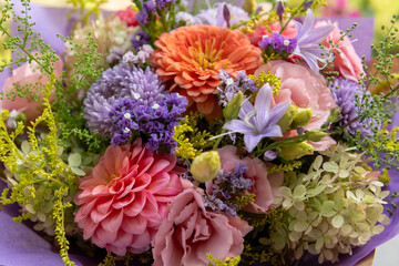 Summer bouquet. Beautiful purple, blush and orange fresh flower arrangement. Birthday or weddding bouquet made of summer flowers.