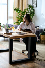 Woman with Waardenburg syndrome focuses on work from home in a cozy environment