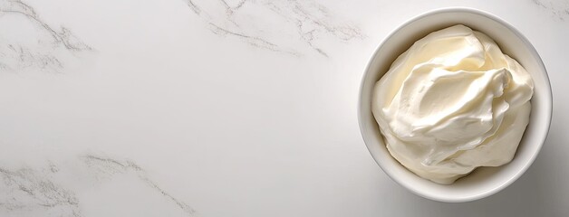 A delightful bowl of creamy sour cream elegantly placed on a marble surface with ample space for creative text or branding