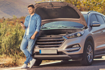 Man with a car problem waiting on an open road © Ljupco Smokovski