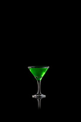 Green cocktail in martini glass on black reflective surface. Concept of creativity and freshness for alcohol branding, digital art, and beverage advertising.