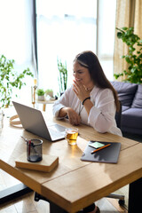 Woman with Waardenburg syndrome enjoying remote work from her cozy home office