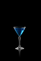 Blue martini drink in elegant glass on black reflective background. Concept of calm freshness, luxury, and modern beauty for product and editorial visuals.