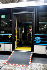 Modern public bus with an open door and deployed accessibility ramp, highlighting inclusive urban transport. Perfect for mobility and city travel concepts.