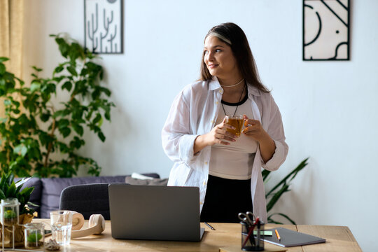 Woman with Waardenburg syndrome enjoys remote work in a cozy home office setting - Powered by Adobe