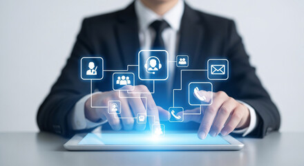 Business professional touching illuminated contact icons on a digital tablet screen for customer service support