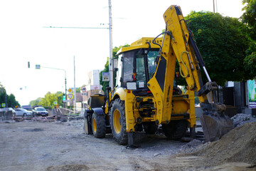 Fototapeta premium Construction machinery working on a road project in an urban area during the day