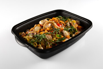 black plastic food container flled with fresh asian salad chinese on white background