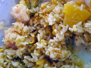 Cagliari, Sardinia, Italy, May 4, 2025. A delicious rice dish, first cooked and then pan-fried with pineapple, mazzancolle or prawns, with the addition of eggs, garlic, oil, and other sweet and savory