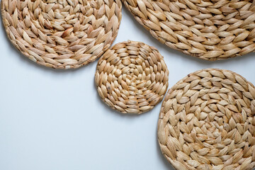 Obraz premium A round woven placemat made from natural water hyacinth isolated on white background