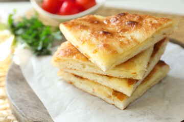 Pieces of delicious Megrelian khachapuri and products on table, closeup