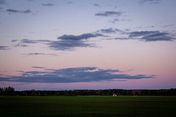 simple minimalist autumn evening landscape with colorful sky and clouds. Latvia, Zemgale