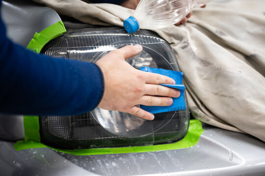 Hand polishing car headlight for restoration process