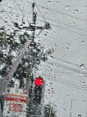 Rainy Day Red Light Observing the Road Through a Wet Window Pane