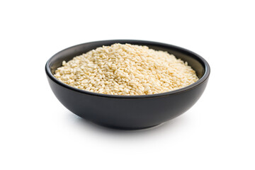 Roasted sesame seeds in bowl isolated on white background.