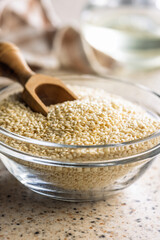 Roasted sesame seeds in bowl on kitchen table.